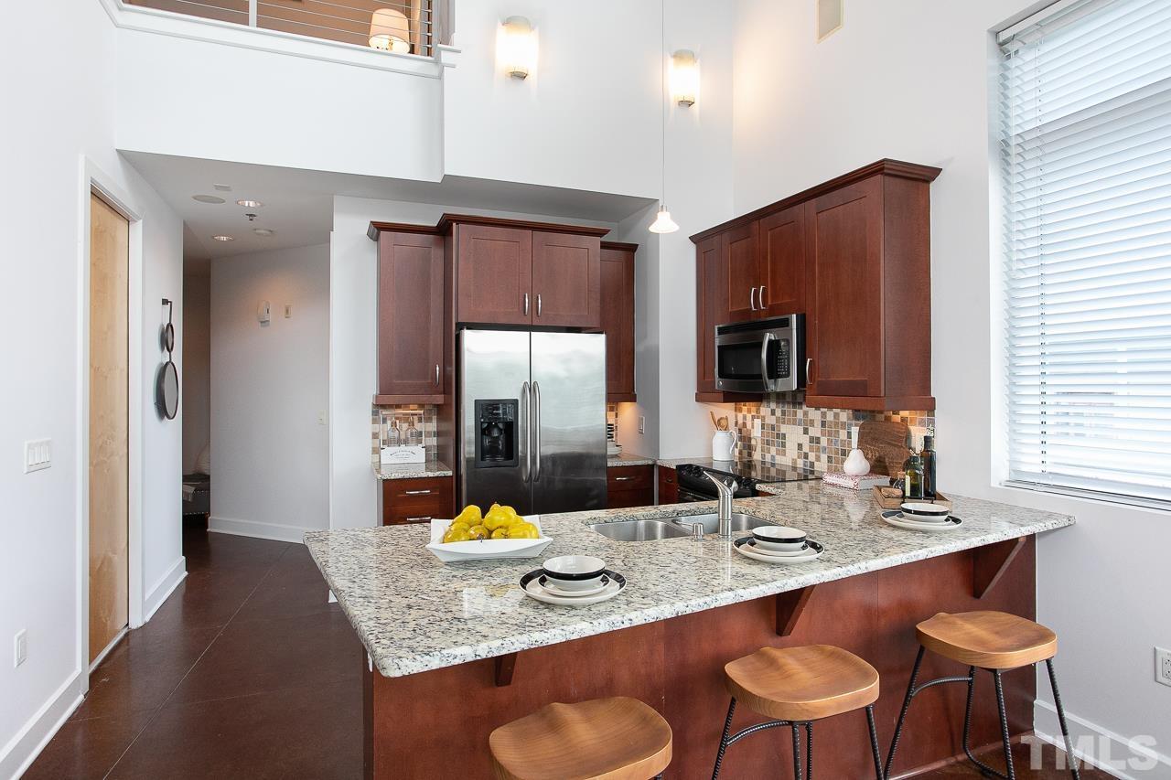 2608 Erwin Road, Unit 402 Durham, NC 27705 - Photo 9 of 33 a bathroom with a granite countertop sink a mirror and a bathtub