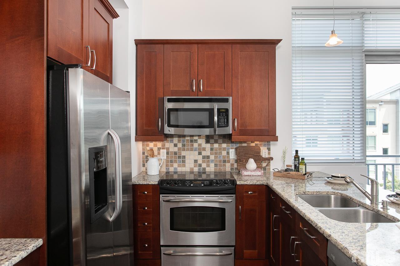 2608 Erwin Road, Unit 402 Durham, NC 27705 - Photo 10 of 33 a kitchen with stainless steel appliances granite countertop a refrigerator stove and sink
