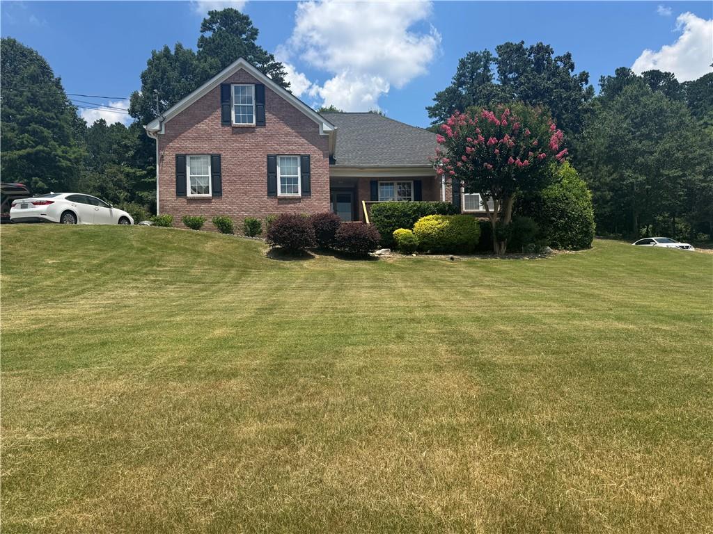 a front view of a house with garden