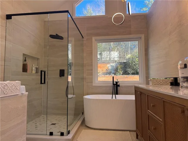 a bathroom with a shower sink and mirror