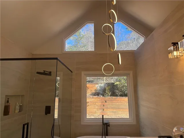 a bathroom with a window and a shower