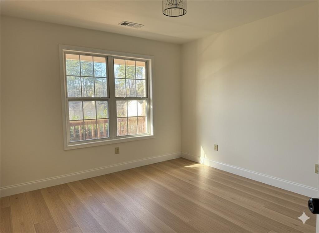 790 Hiram Davis Road Lawrenceville, GA 30045 - Photo 17 of 21 an empty room with wooden floor and windows