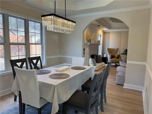 a view of a dining room with furniture large window and wooden floor