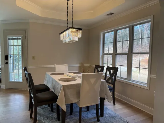 a view of a dining room with furniture window and wooden floor