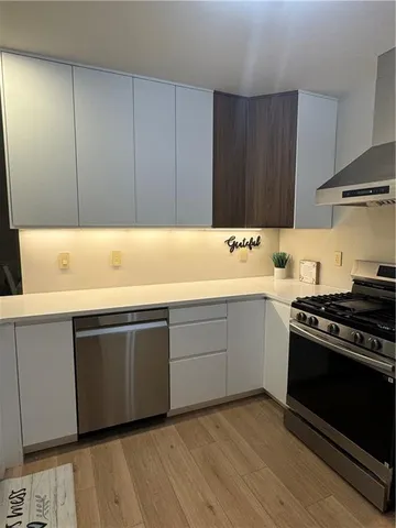 a kitchen with wooden cabinets and a stove top oven