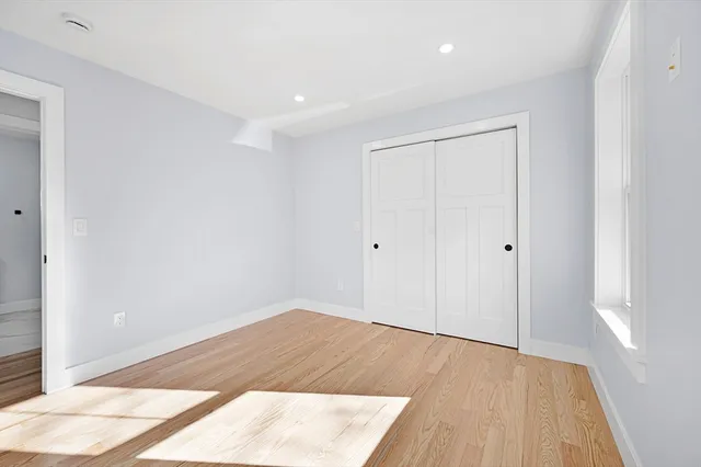 an empty room with wooden floor