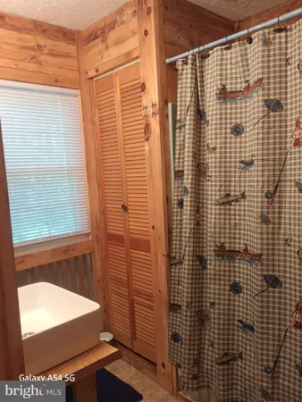a bedroom with a bed chair and window