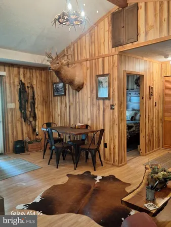 a room with gym equipment and wooden floor