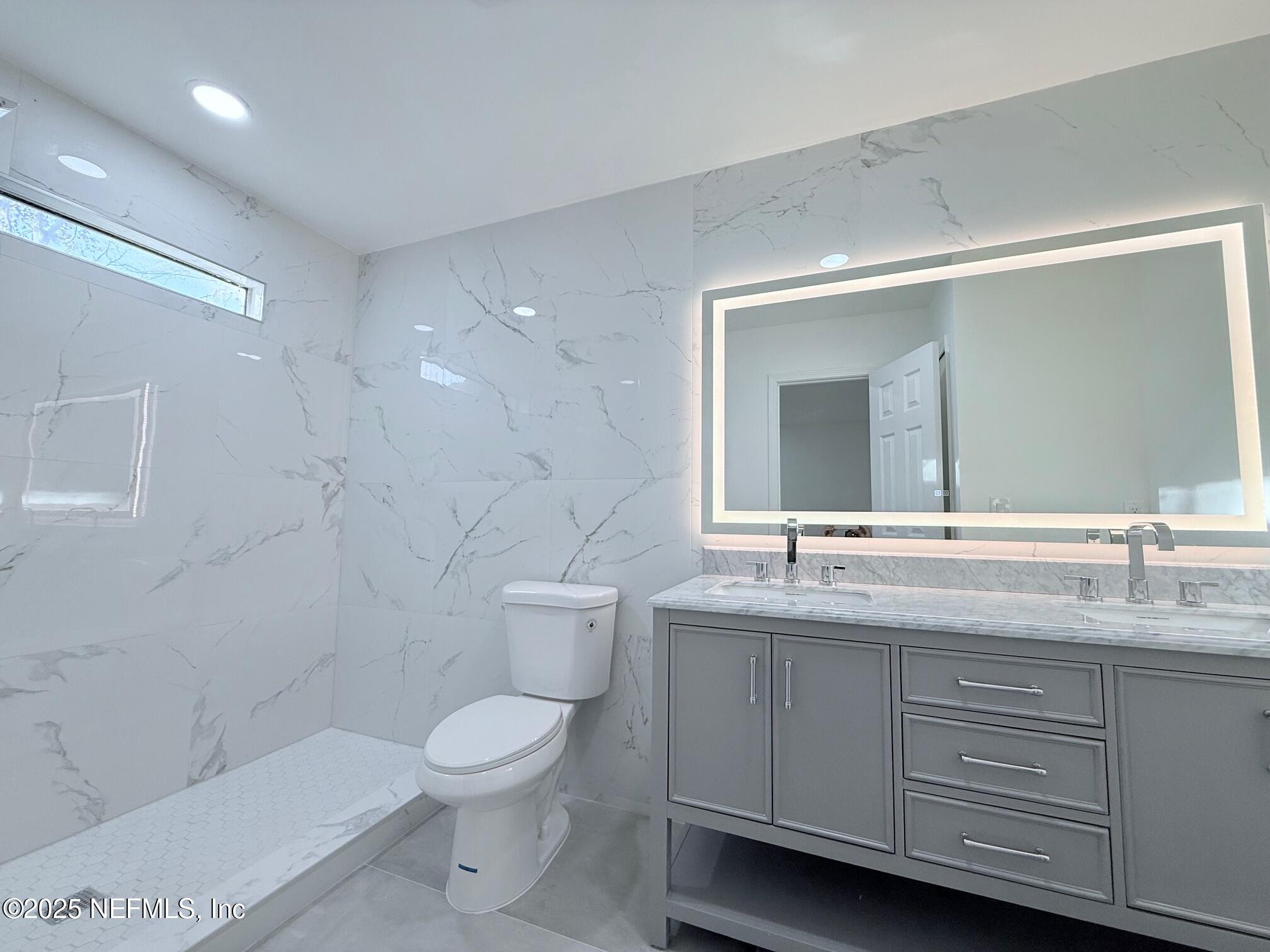 2160 Rothbury Drive Jacksonville, FL 32221 - Photo 12 of 31 a bathroom with a toilet sink and mirror