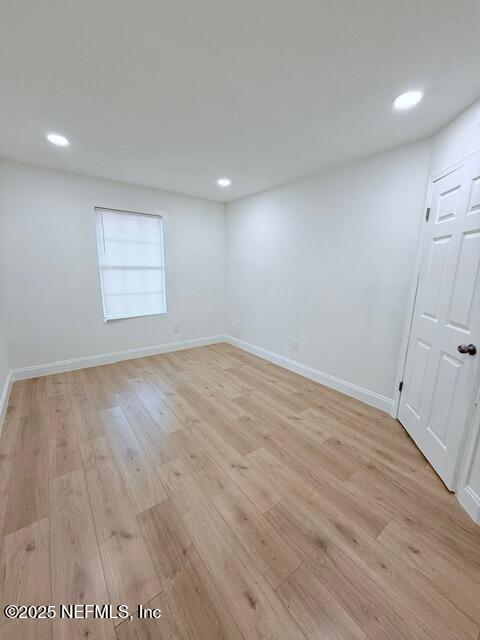 2160 Rothbury Drive Jacksonville, FL 32221 - Photo 27 of 31 an empty room with wooden floor and windows