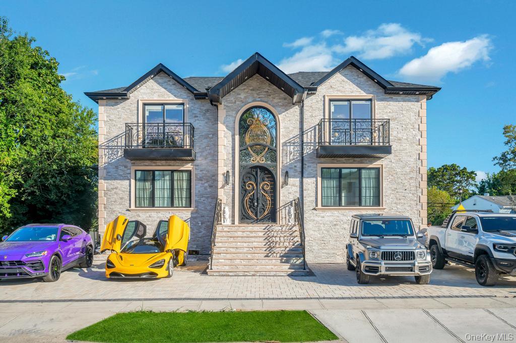 a front view of a house with large garden