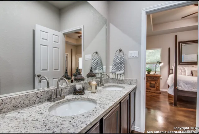 a bathroom with sinks granite countertop a sink and a mirror