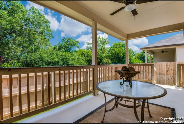a view of a balcony with table and chairs and wooden floor
