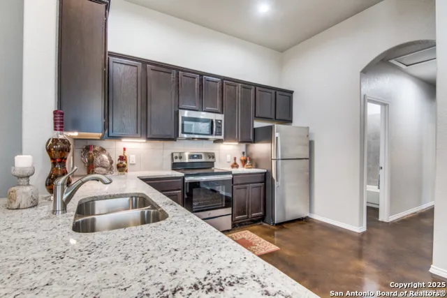 a kitchen with a sink stove and refrigerator