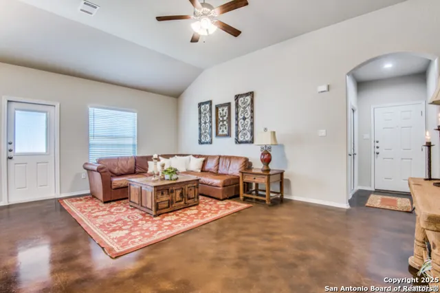 a living room with furniture rug and window