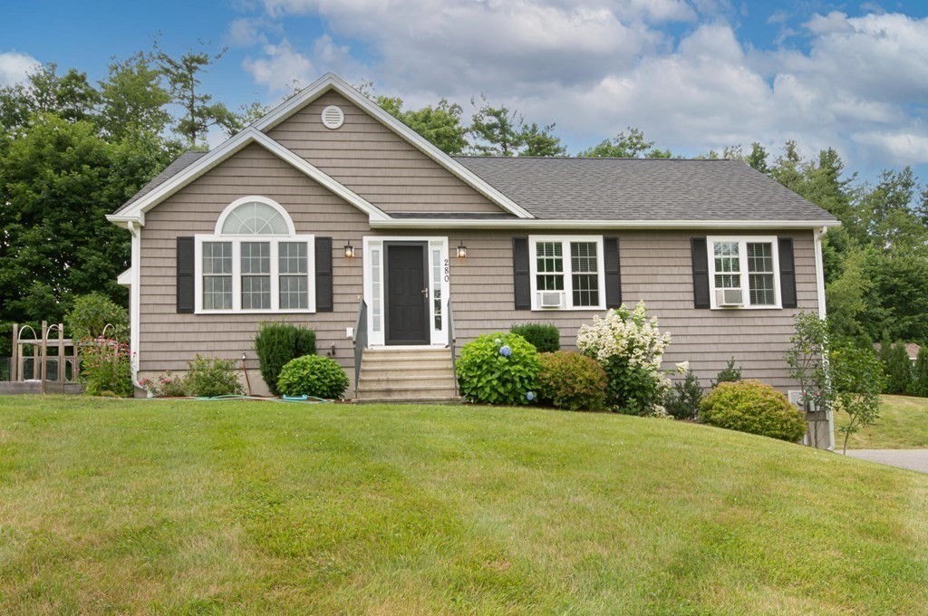 a front view of a house with garden
