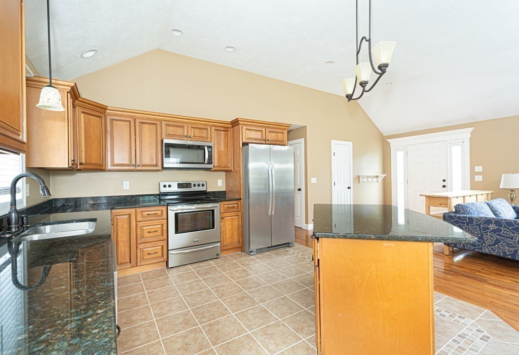 280 Maple Avenue Rutland, MA 01543 - Photo 12 of 35 a kitchen with stainless steel appliances granite countertop a sink a stove top oven a counter space and cabinets