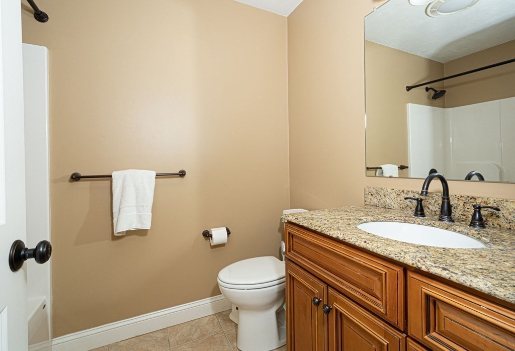280 Maple Avenue Rutland, MA 01543 - Photo 22 of 35 a bathroom with a granite countertop sink toilet and shower