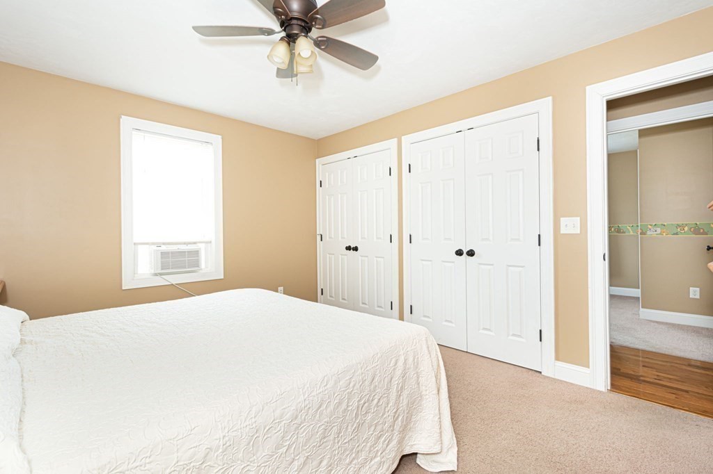 280 Maple Avenue Rutland, MA 01543 - Photo 24 of 35 a bedroom with a large bed and a chandelier fan
