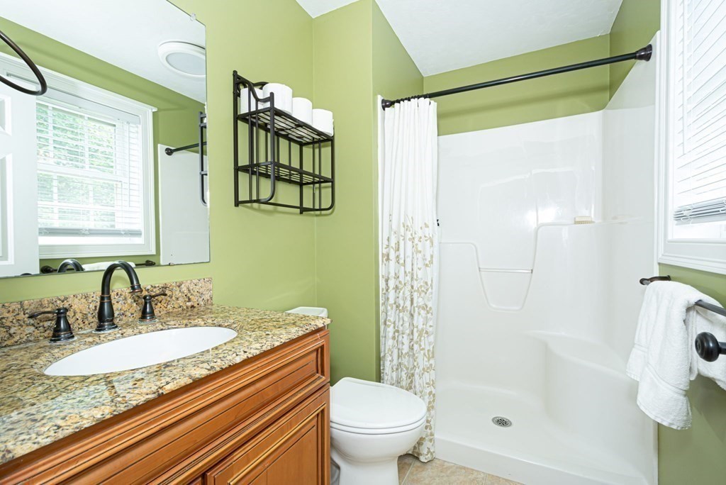280 Maple Avenue Rutland, MA 01543 - Photo 30 of 35 a bathroom with a granite countertop sink toilet and shower