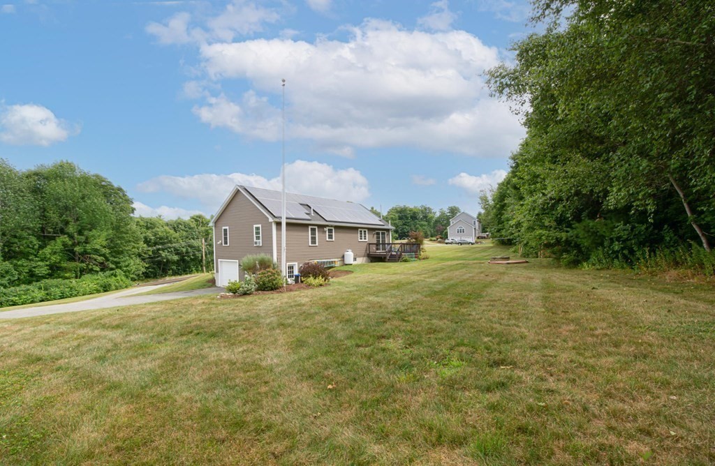 280 Maple Avenue Rutland, MA 01543 - Photo 5 of 35 a view of a house with a big yard and large trees