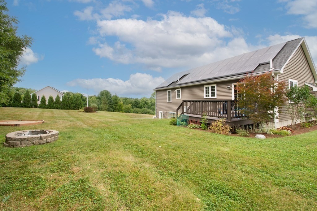 280 Maple Avenue Rutland, MA 01543 - Photo 6 of 35 a view of a house with a yard and sitting area