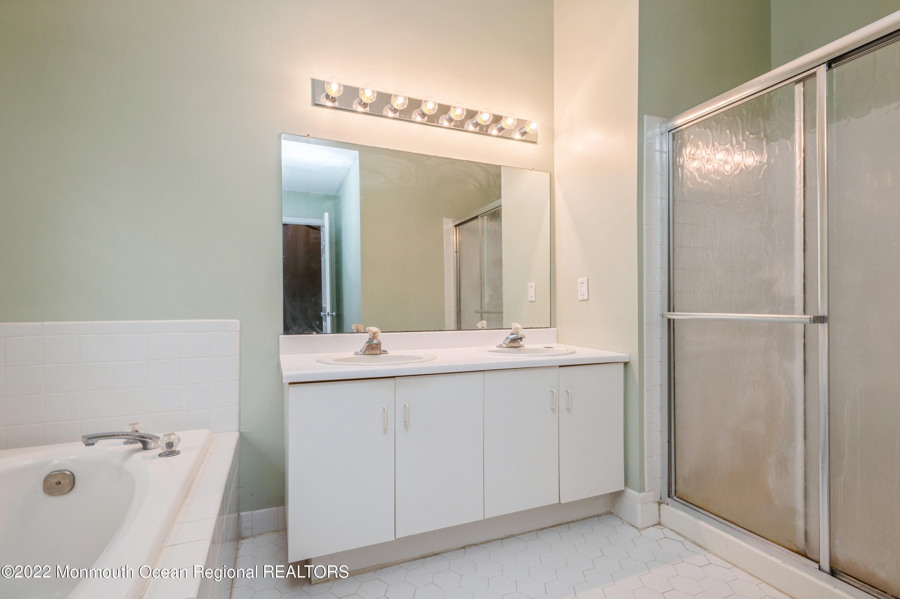 48 Alpine Road Holmdel, NJ 07733 - Photo 16 of 20 a bathroom with a double vanity sink and mirror