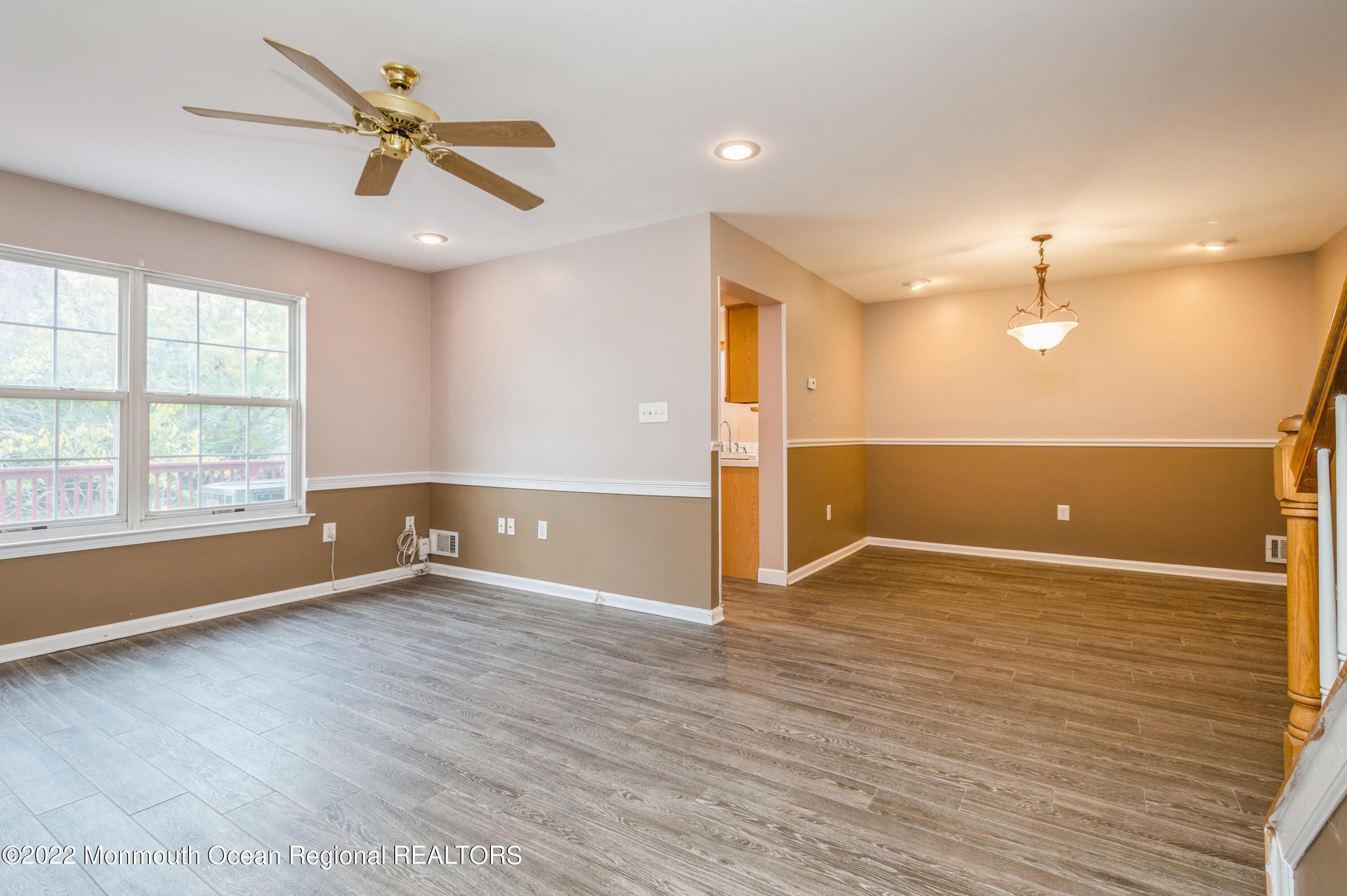 48 Alpine Road Holmdel, NJ 07733 - Photo 6 of 20 a view of an empty room with a window and wooden floor