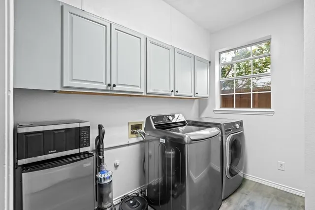 a view of a storage and utility room with washer and dryer