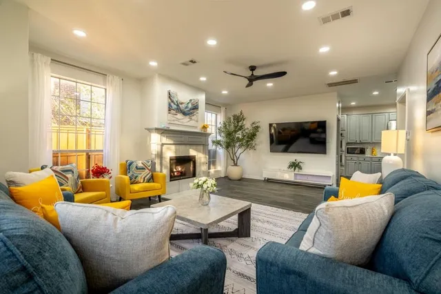 a living room with fireplace furniture and a flat screen tv