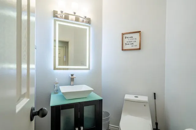 a bathroom with a toilet sink and mirror