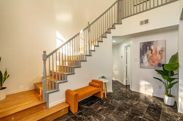 a view of entryway and hall with wooden floor