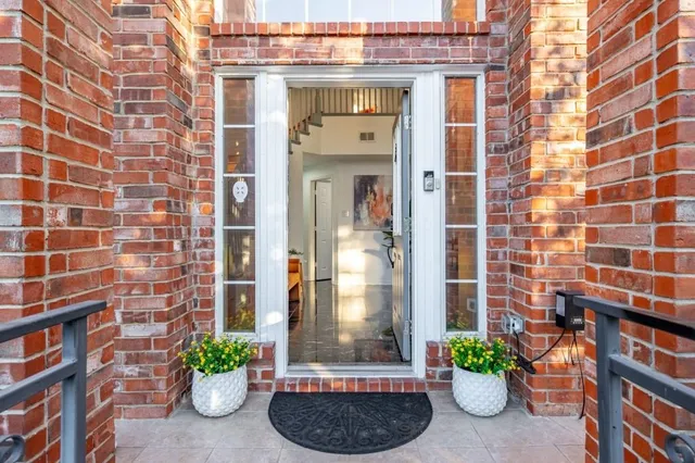 a view of a brick house with potted plants