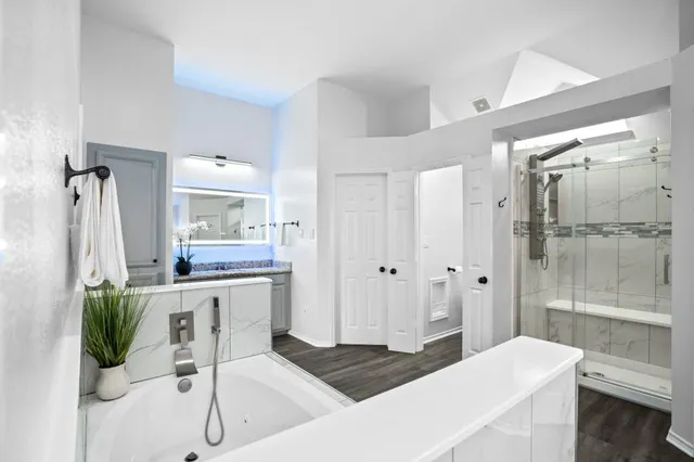 a spacious bathroom with a granite countertop sink and a mirror