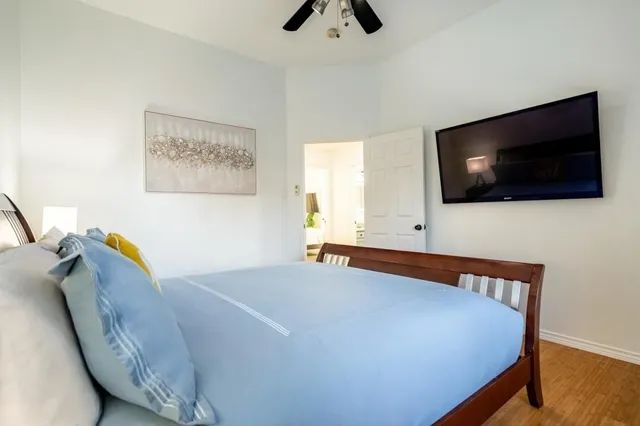 a bedroom with a bed and a flat screen tv