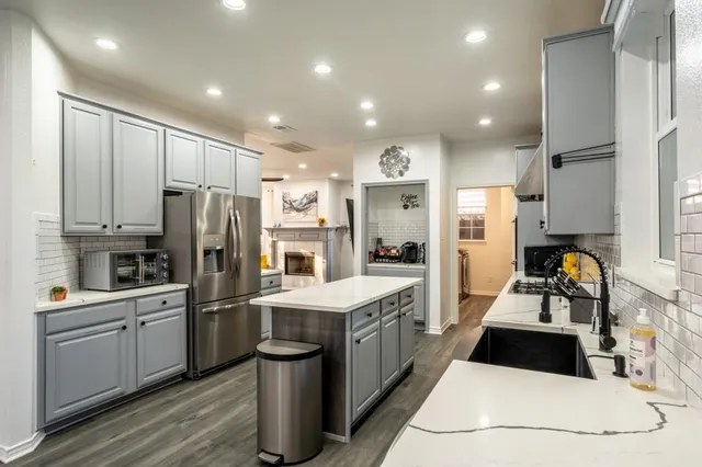 a kitchen with refrigerator a sink and cabinets