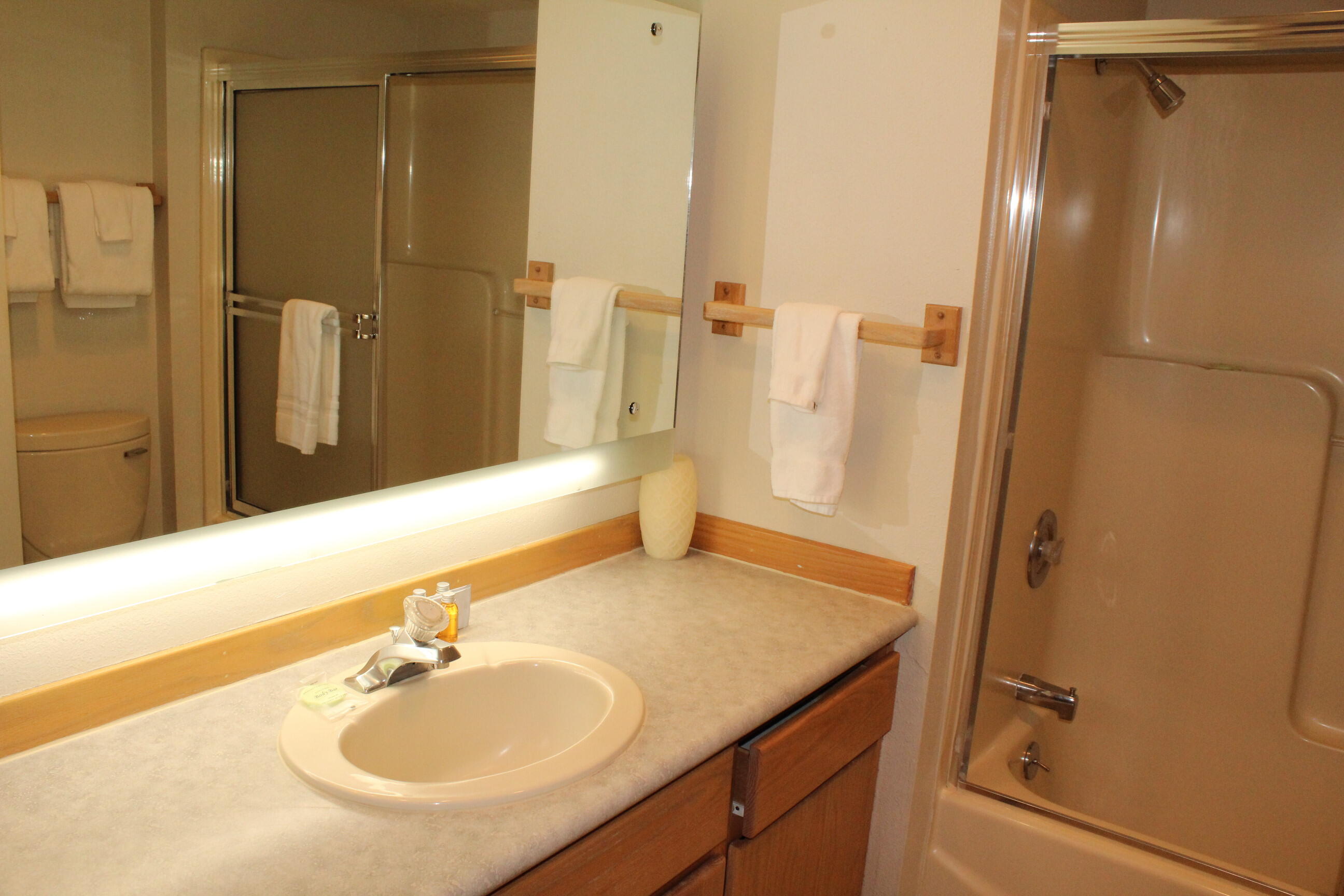 57407-44c Beaver Ridge Loop Sunriver, OR 97707 - Photo 11 of 24 a bathroom with a granite countertop sink and a mirror