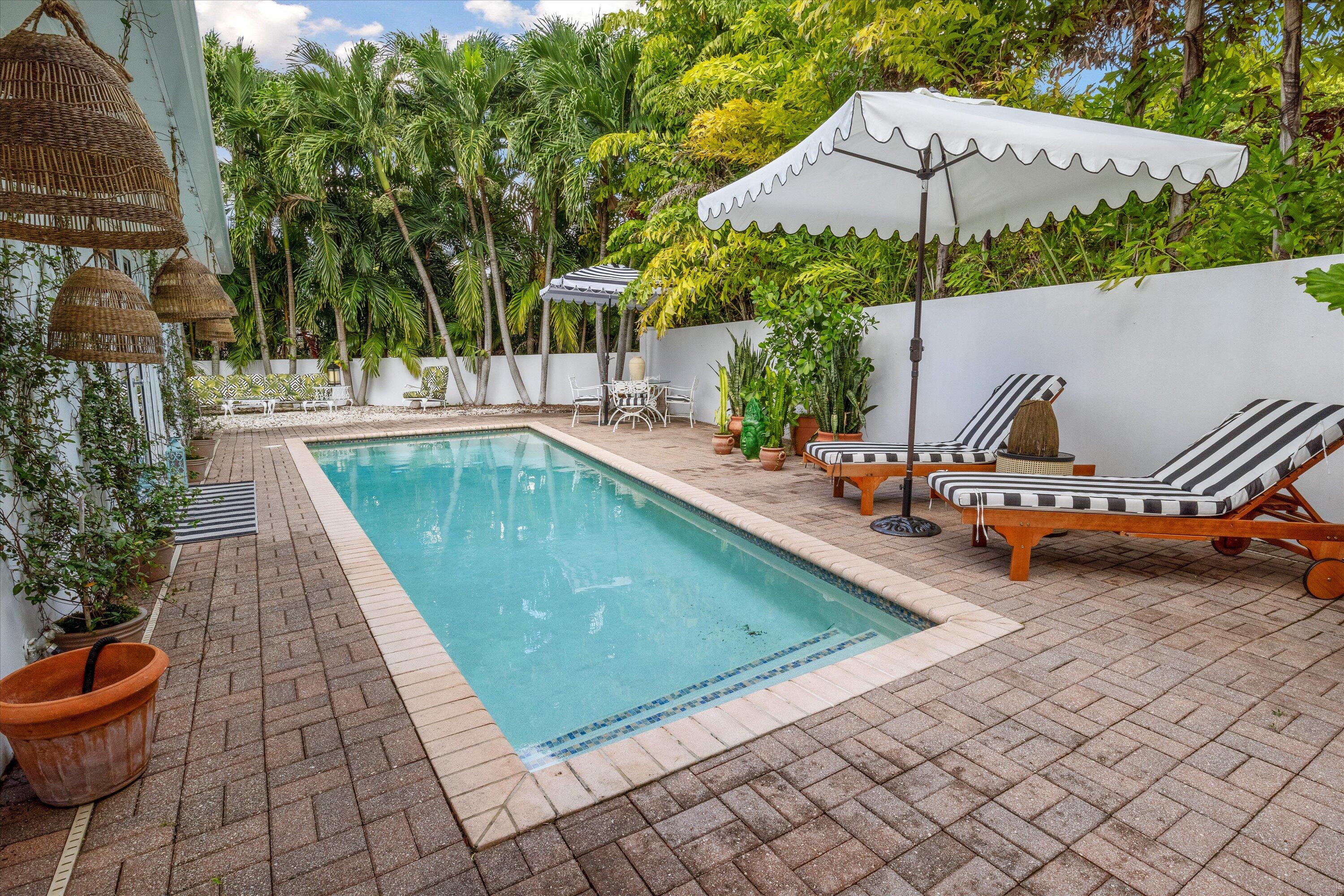 202 32nd Street West Palm Beach, FL 33407 - Photo 12 of 44 an outdoor space with swimming pool and furniture