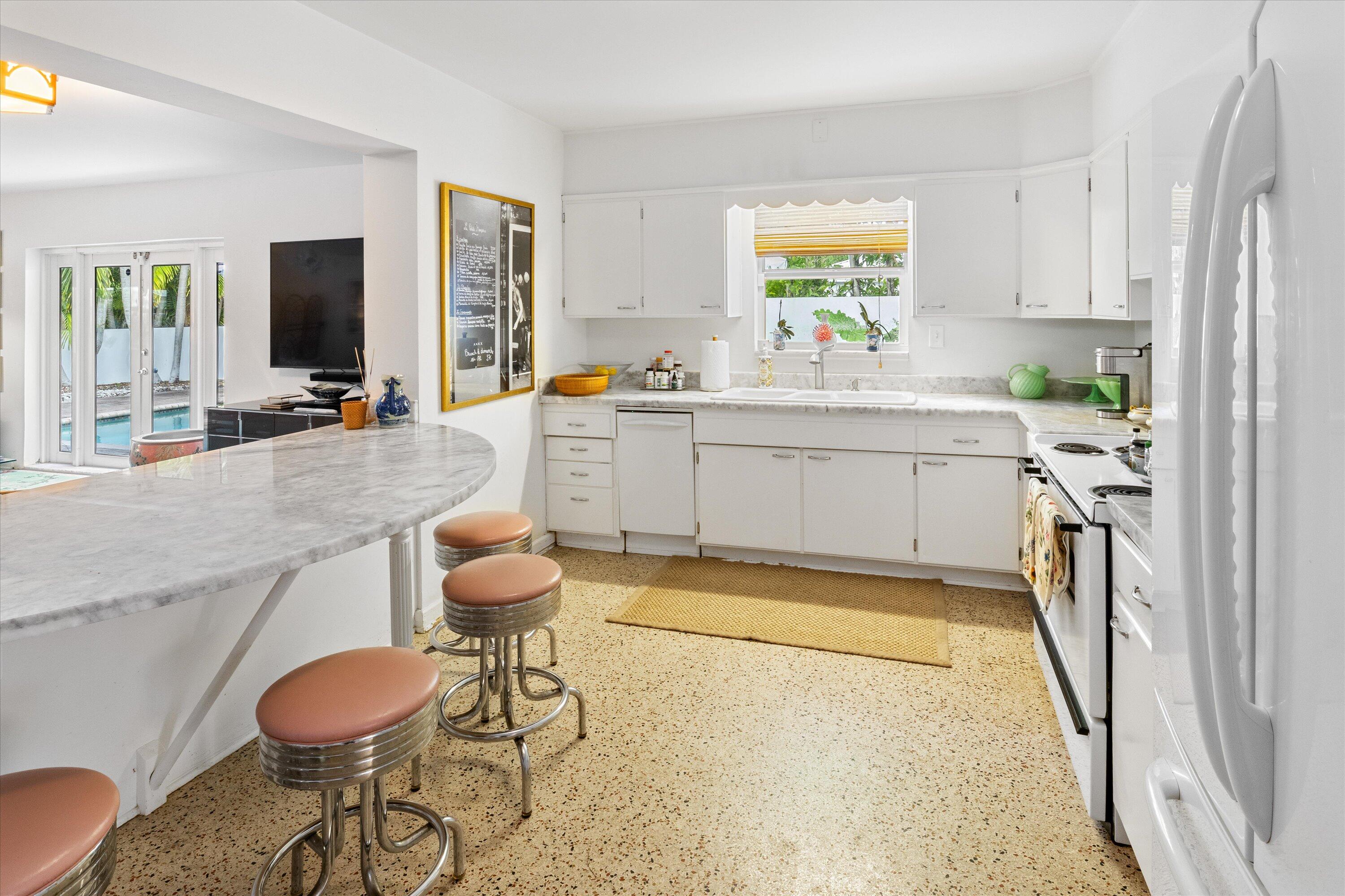 202 32nd Street West Palm Beach, FL 33407 - Photo 19 of 44 a kitchen with stainless steel appliances a sink and a large window