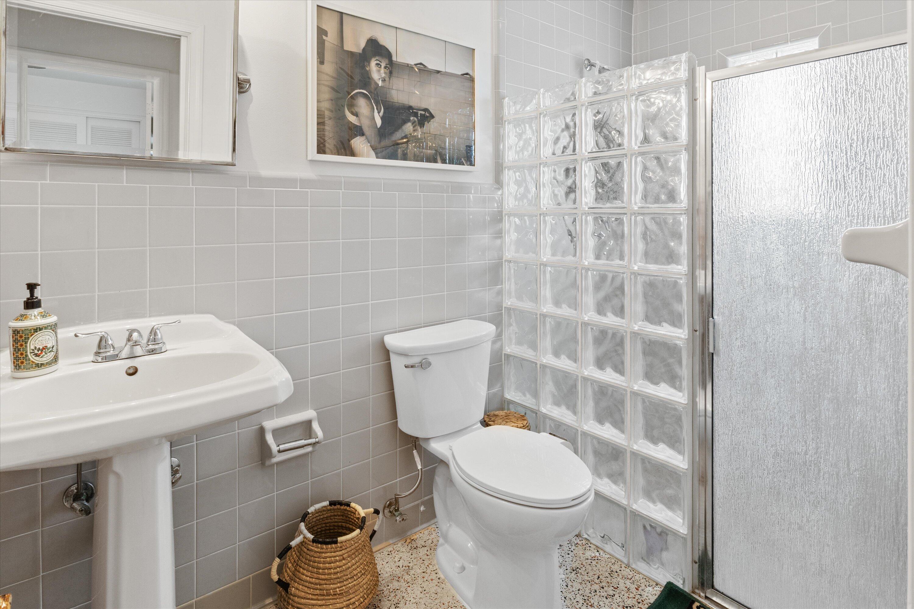 202 32nd Street West Palm Beach, FL 33407 - Photo 25 of 44 a bathroom with a toilet sink and mirror