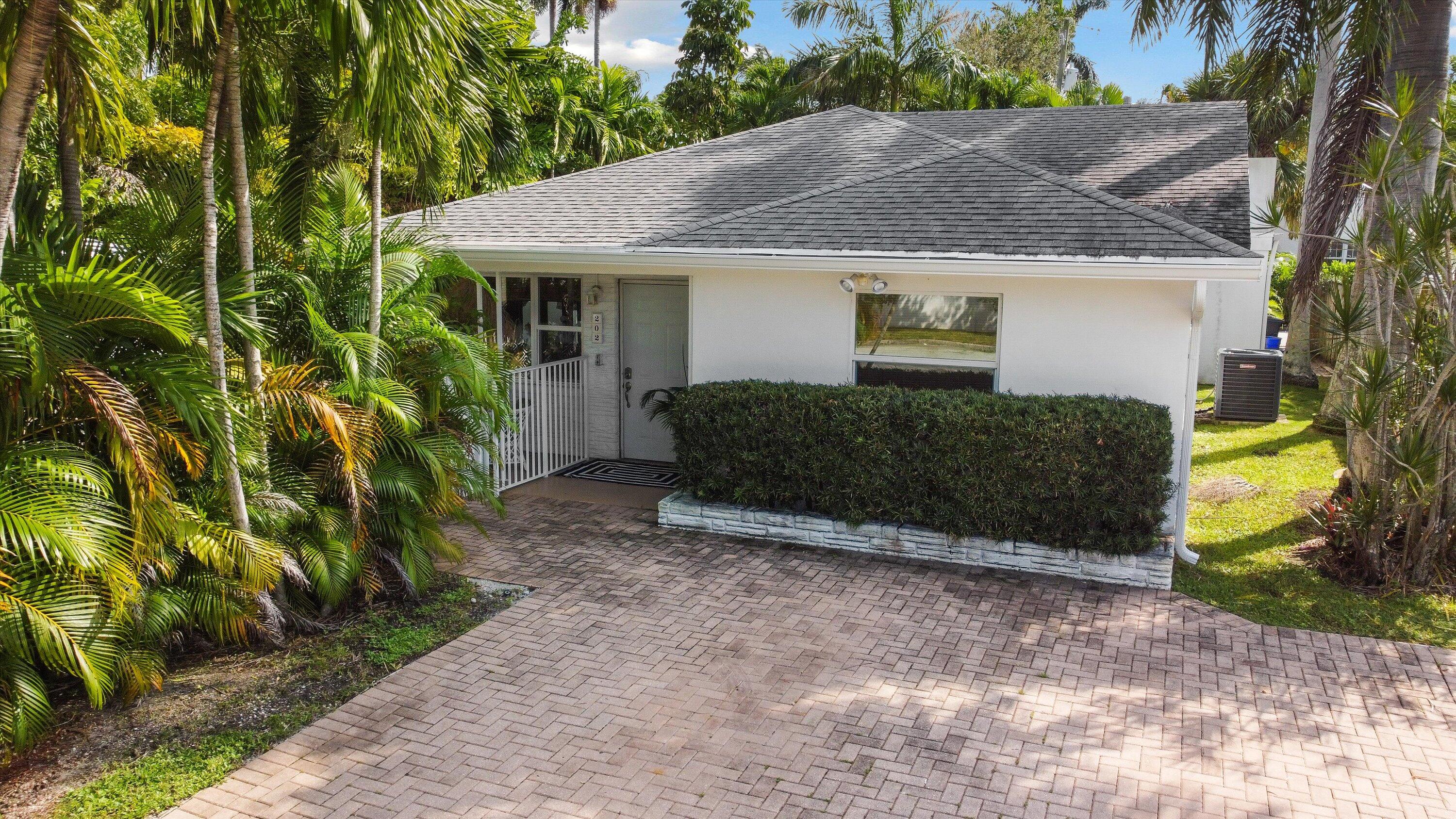 202 32nd Street West Palm Beach, FL 33407 - Photo 7 of 44 a view of a house with a yard and plants