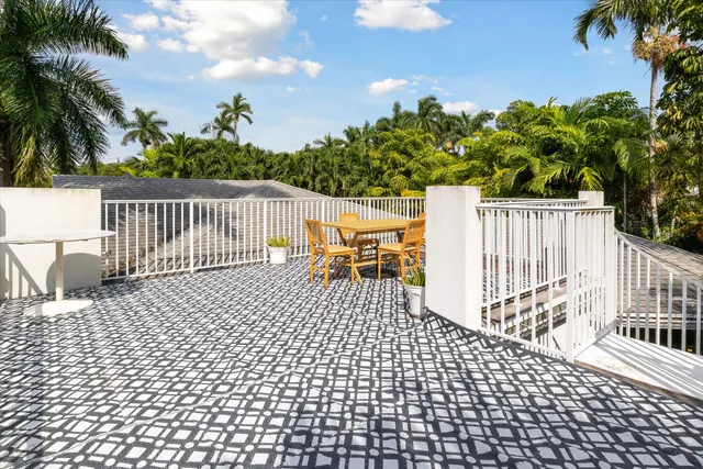 an outdoor space with swimming pool and furniture