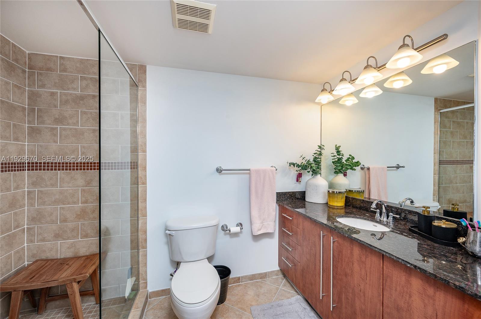 7350 Southwest 89th Street, Unit 1702S Miami, FL 33156 - Photo 11 of 29 a spacious bathroom with a granite countertop sink a toilet and a mirror
