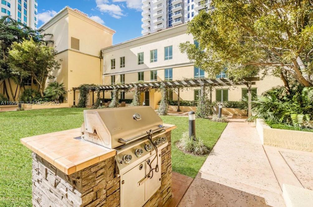 7350 Southwest 89th Street, Unit 1702S Miami, FL 33156 - Photo 13 of 29 a view of a white house with a yard and sitting area