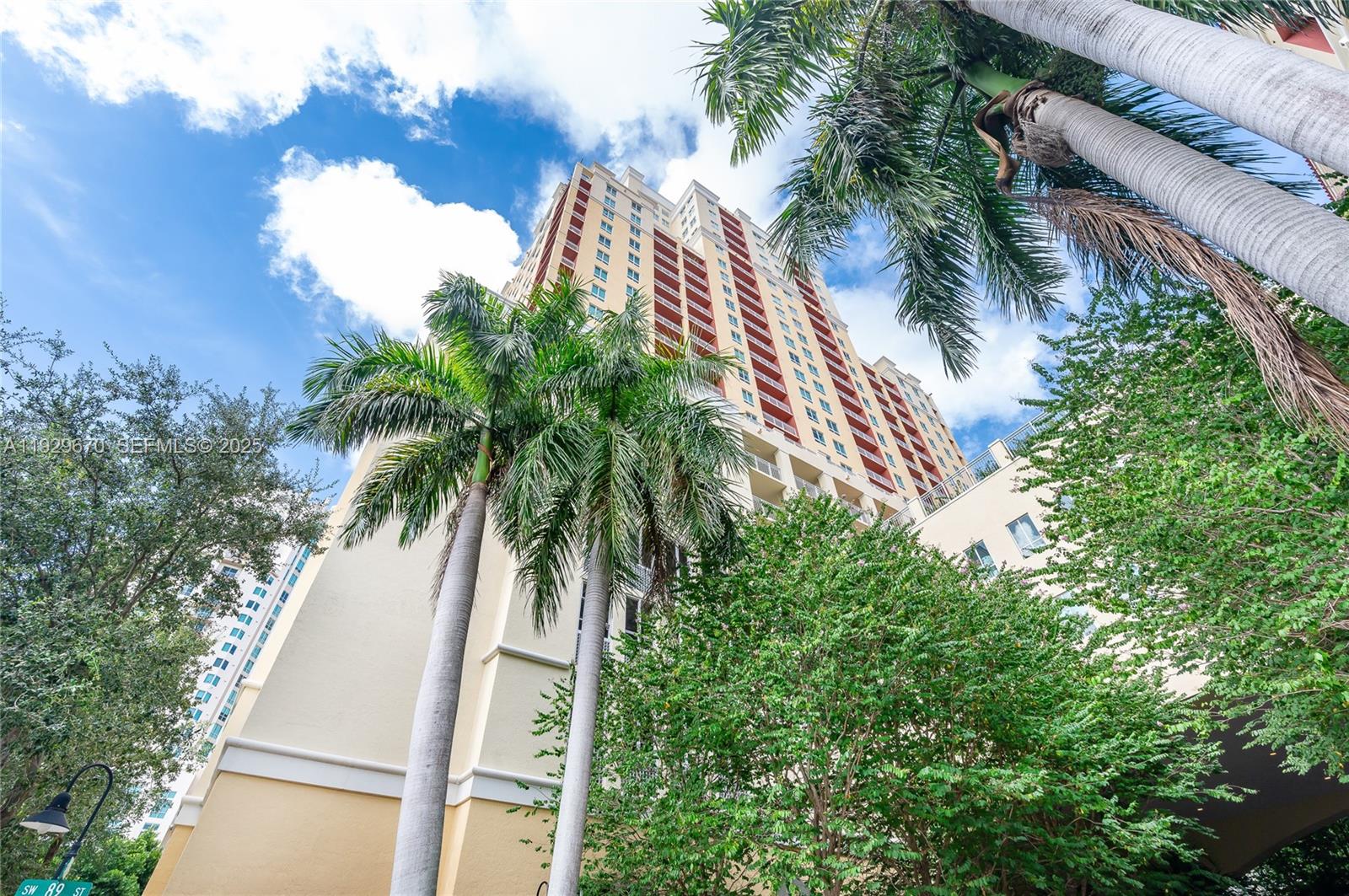 7350 Southwest 89th Street, Unit 1702S Miami, FL 33156 - Photo 18 of 29 a view of a palm trees in front of a house