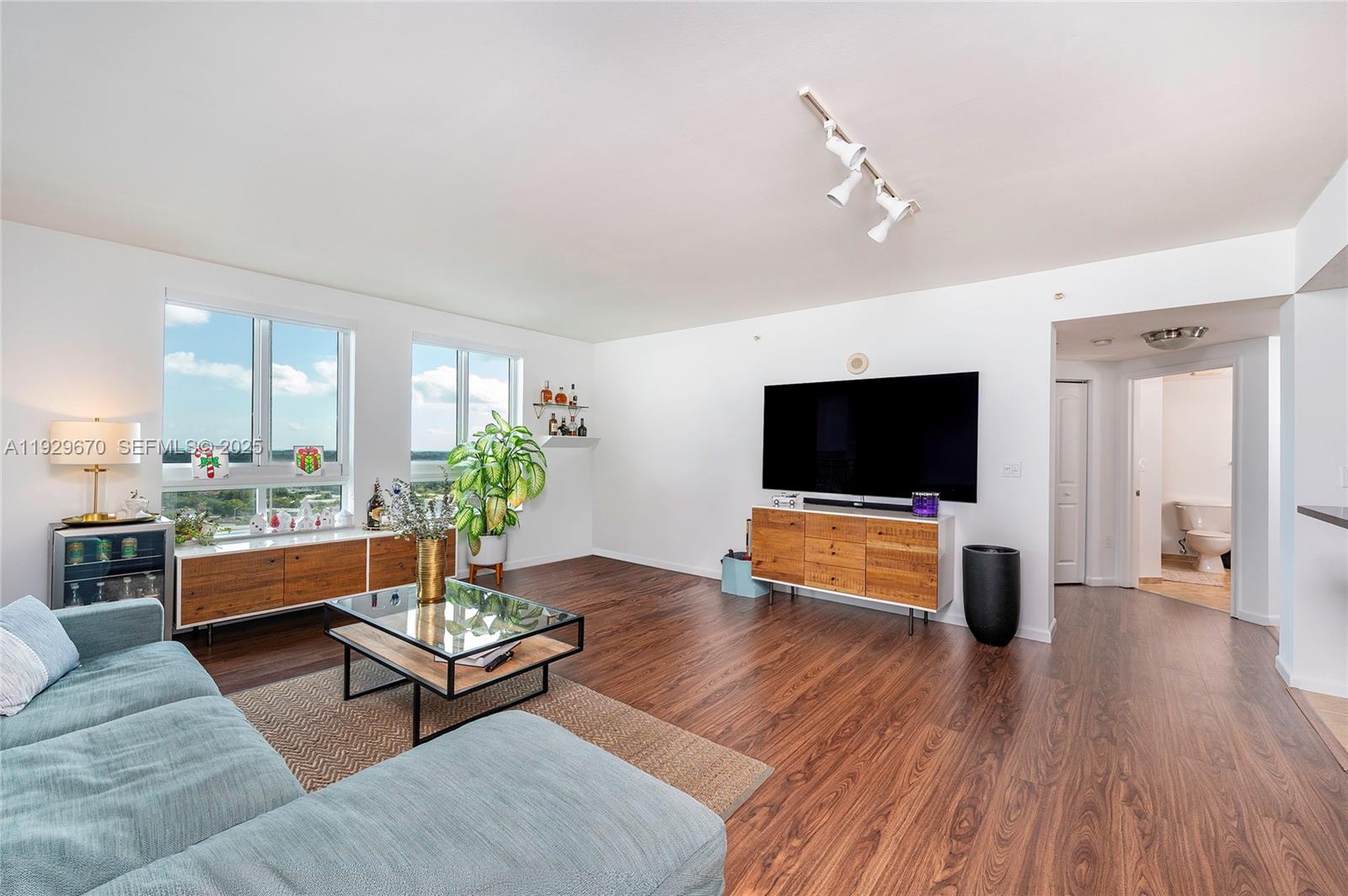 7350 Southwest 89th Street, Unit 1702S Miami, FL 33156 - Photo 3 of 29 a living room with furniture and a flat screen tv