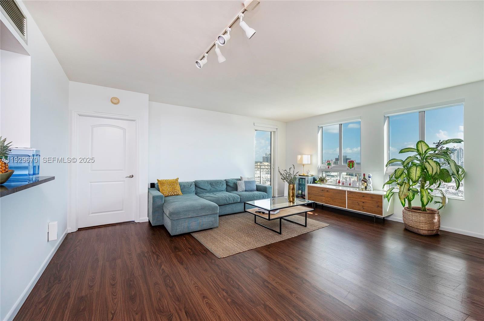 7350 Southwest 89th Street, Unit 1702S Miami, FL 33156 - Photo 4 of 29 a living room with furniture and a wooden floor