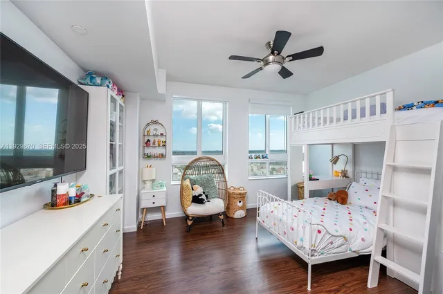 a bedroom with furniture and a large window