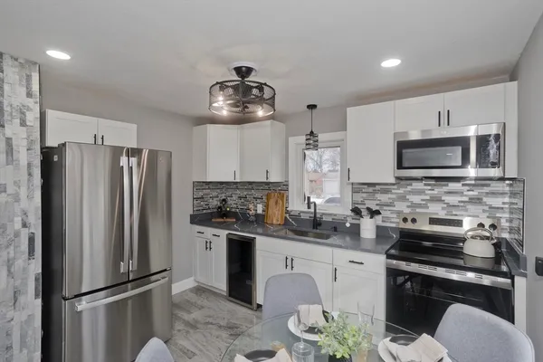 a kitchen with stainless steel appliances a refrigerator stove microwave and cabinets