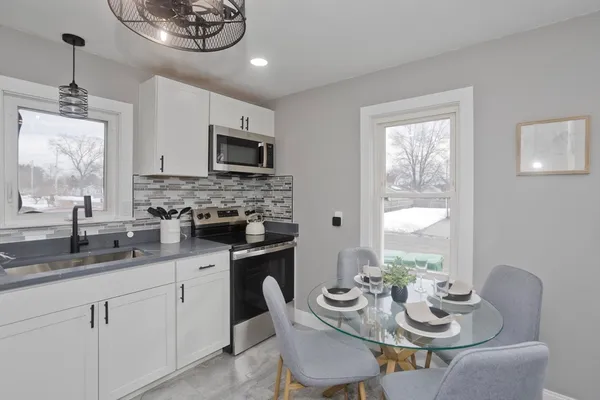 a kitchen with stainless steel appliances kitchen island granite countertop a sink and cabinets